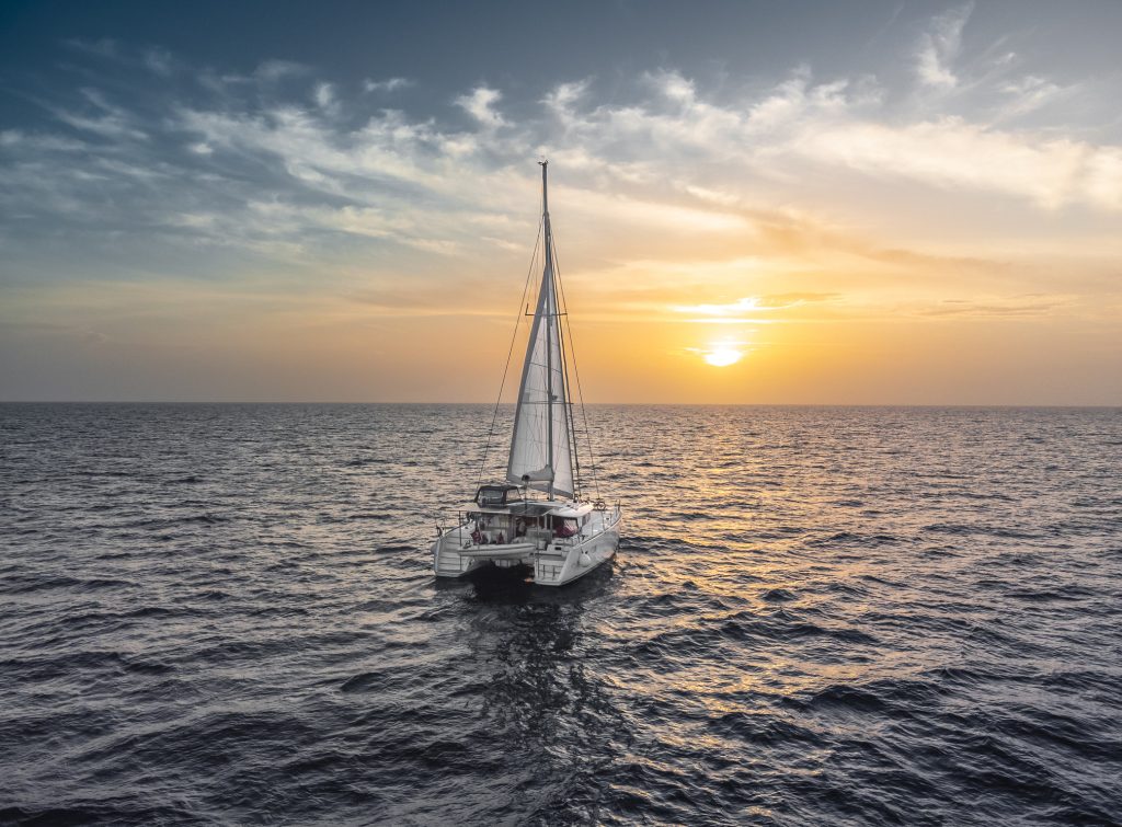 sailing catamaran caribbean bahamas turquoise water sunset